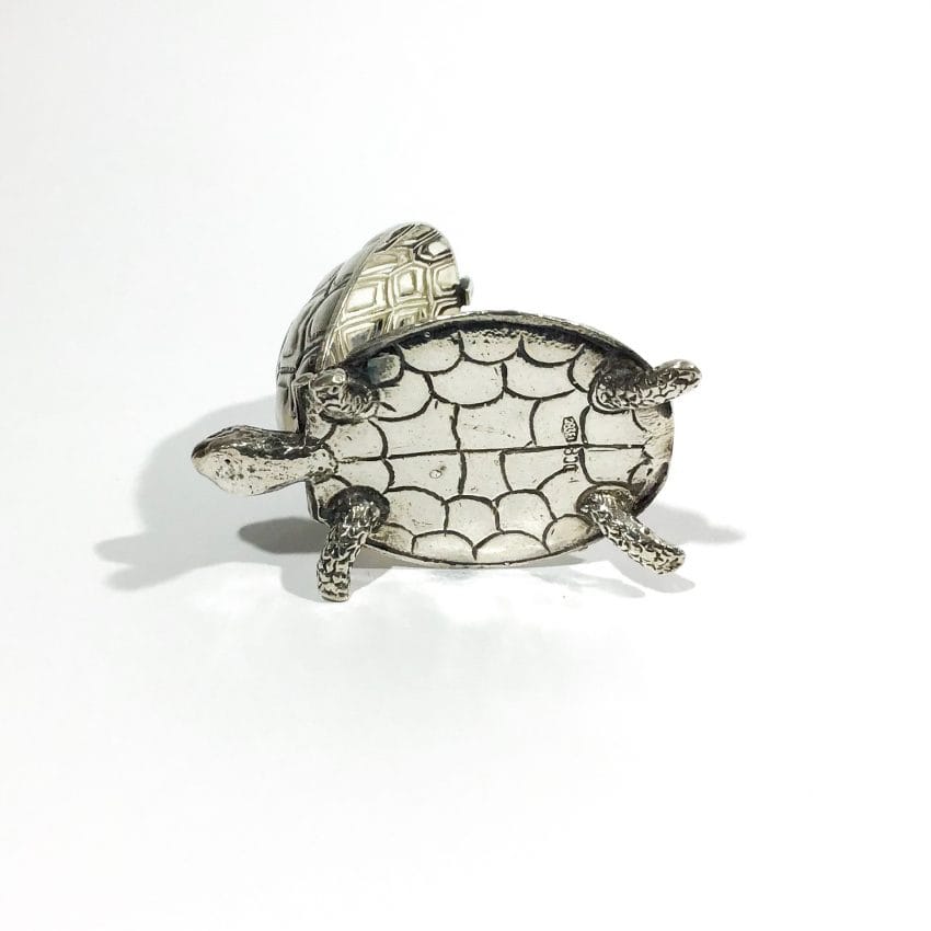 silver punch pad holder in the shape of a turtle