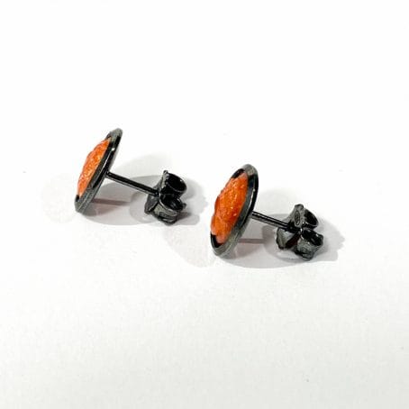 detail of earrings with red coral cameo