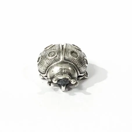 ladybird-shaped silver tablet holder detail