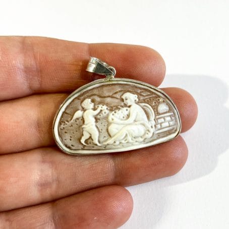 cameo pendant with romantic scene